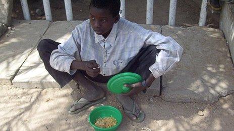 A child beggar receives food in Kano, Nigeria (Archive shot)