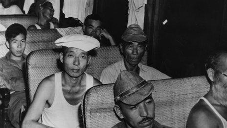 Japanese-Americans on a bus on their way to an internment camp in April 1942