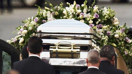 Houston's casket is taken from the church, 18 Feb