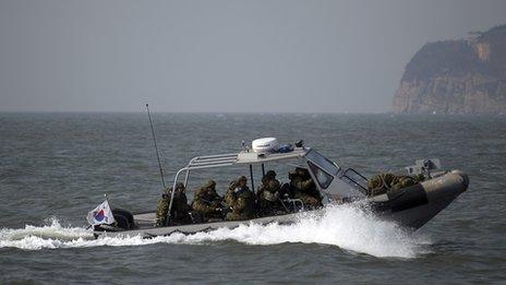 South Korean naval personnel go on a boat patrol near Yeonpyeongdo island as South Korean marines conduct live fire exercise on the island in Ongjin county, off Incheon, west of Seoul February 20, 2012