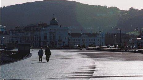 Couple stroll on Llandudno promenade