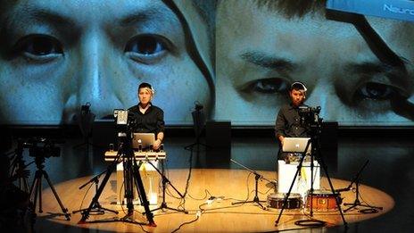 Multi-media artist Samson Young, left, during a performance of his work in Hong Kong last year