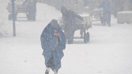A woman in a snow storm in Kabul, Afghanistan (Feb 2012)