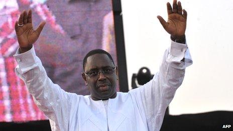 Senegalese opposition candidate Macky Sall greets the crowd during a meeting on 12 March 2012 in Dakar, Senegal