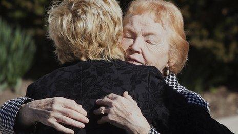 The mother of Marie Colvin, Rosemarie, is embraced at her daughter's funeral