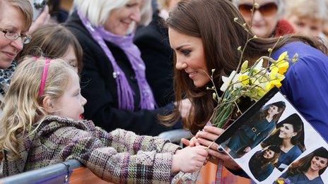 Duchess of Cambridge talks to a young girl during a visit to EACH, Ipswich