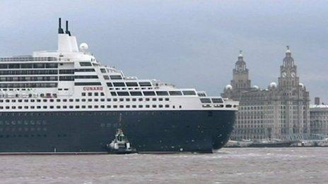 Cruise liner passing Liverpool's historic waterfront