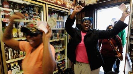 Tammy Redlen (C) and Sierra Luchien (L) are jubilant as they walk in Blue Bird liquor store after waiting in line for nearly three hours to purchase their Mega Millions lottery ticket on March 29, 2012 in Hawthorne, California.