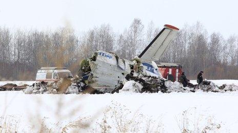 Emergency service workers investigate the wreckage of the UTair airlines ATR 72 passenger plane that crashed near the Siberian city of Tyumen, 2 April