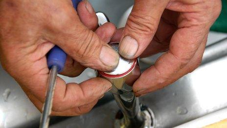 Plumber changing a tap