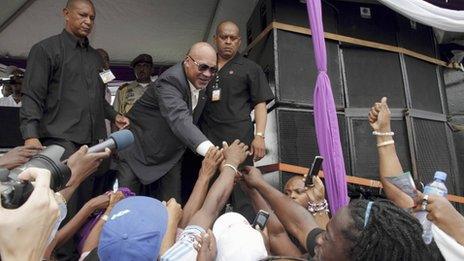 Suriname's President Desi Bouterse greets supporters that have gathered in front of Parliament in Paramaribo March, 23, 2012.