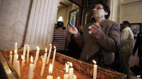 A woman prays on Palm Sunday in a church in Damascus, 1 April 2012