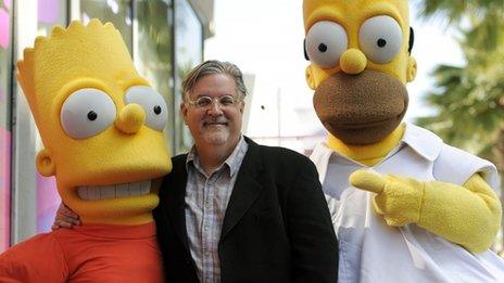 Matt Groening, creator of The Simpsons, stands between Bart and Homer Simpson in a file picture 14 February 2012