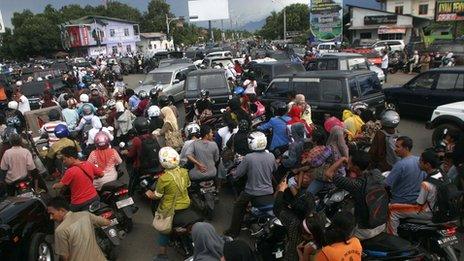 Crowds of people try to make it to higher ground in Aceh, Sumatra, Indonesia.