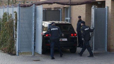 Danish police meet a car carrying one of the defendants to court in Glostrup, Copenhagen, 13 April