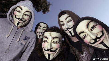 Protesters wearing 'Anonymous' masks