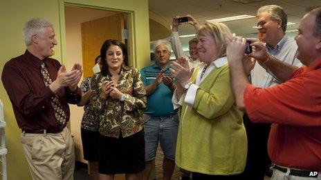 Patriot-News reporter Sara Ganim (second left) and colleagues celebrate their Pulitzer Prize at their office in Harrisburg, Pennsylvania on 16 April 2012