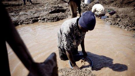 A child washes copper at an open-air mine in Kamatanda in the rich mining province of Katanga