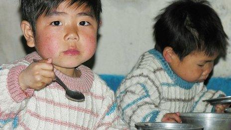 North Korean boys eat lunch in a government-run nursery