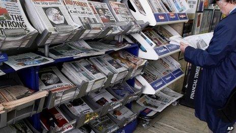 Headlines on British newspapers at a newsagent shop in London