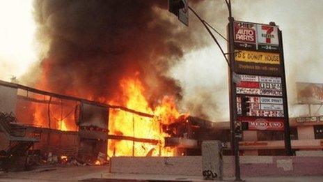 A shopping centre in Koreatown, Los Angeles, burning during the riots, 1 May 1992