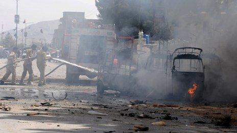 Pakistani firefighters extinguish burning auto-rickshaws after a bomb explosion in Quetta on May 1, 2012.