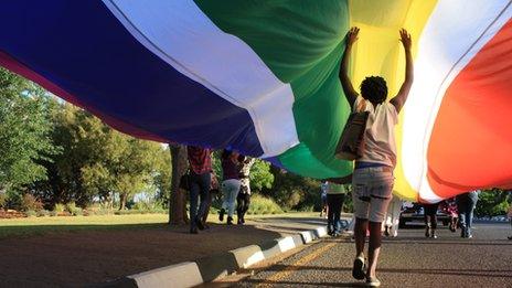Person walking under a huge rainbow flag
