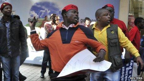 An angry COSATU supporter throws stones during a march by the Democratic Alliance (DA) South Africa's main opposition party in Johannesburg May 15, 2012.