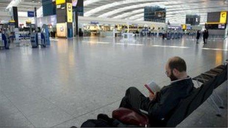 Man waiting at Heathrow airport April 2010