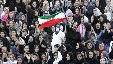 Women cheer at a friendly football match in Tehran in 2006