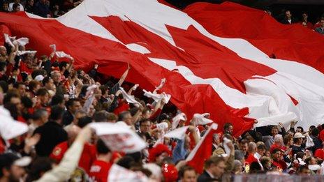 Sports fans with a giant Maple Leaf flag