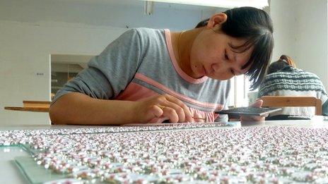 A worker making costume jewellery