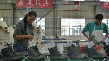 A picture taken on April 19, 2012 shows people working on the assembly line at Huajian shoe factory in Dukem, Ethiopia.