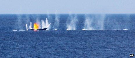 This image taken between March and April 2012 and released by the UK's Royal Navy Wednesday 16 May 2012 shows a Somali pirate skiff being fired at by a naval ship