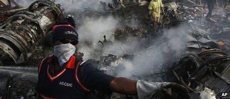 Rescue workers search for bodies at the site of a plane crash in Lagos, Nigeria, Monday, June 4, 2012.
