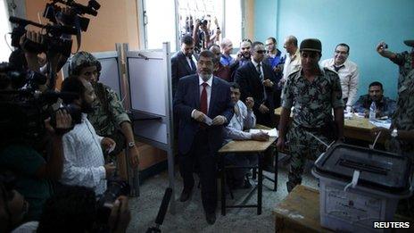 Presidential candidate Mohammed Mursi of the Muslim Brotherhood casts his vote at a polling station