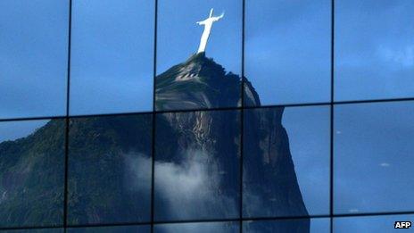 Christ the Redeemer statue reflected in the windows of a business building (15 June 2012)