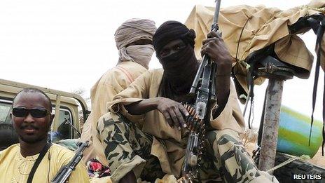 Ansar Dine militants pose in the northern Malian city of Gao on 18 June 2012