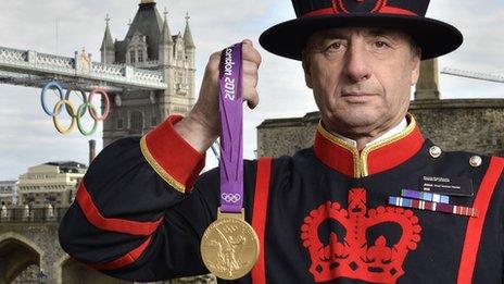 A Yeoman Warder at the Tower of London with an Olympic medal