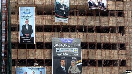 Electoral campaign posters hang from a building under construction on 4 July 2012 in the Libyan capital Tripoli