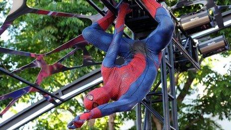 A costumed actor performs at The Amazing Spider-Man's Los Angeles premiere