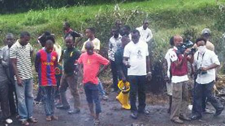 Crowds look on at the scene of the petrol tank explosion in Okogbe, Rivers state, Nigeria - 12 July 2012