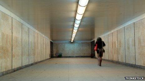 Woman walking with handbag in a tunnel