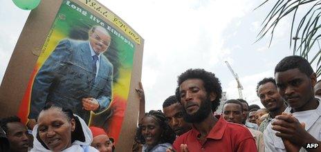 People celebrate with a poster Prime Minister Mele Zenawi's the Ethiopian People's Revolutionary Front (EPRDF)'s 20 years in power - 28 May 2011