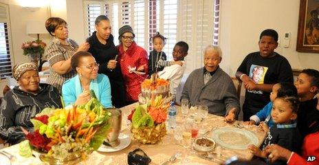 Former South African President Nelson Mandela celebrates his 94th birthday with his wife Graca Machel, second from left front, and other family members at his home in Qunu, South Africa, on Wednesday