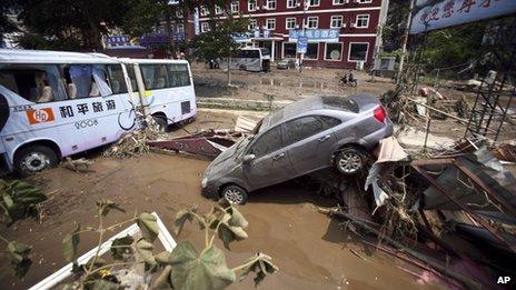 Vehicles damaged in a flood pile up off road in Yesanpo Scenic Zone, a resort near the capital Beijing, in Laishui county, in northern China's Hebei province.