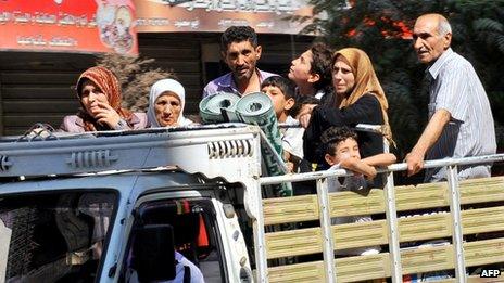 People leave the Aleppo city centre after shelling by Syrian government forces on 26 July