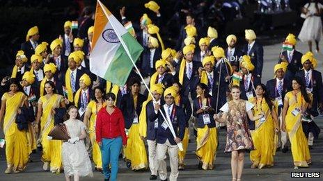 India's Olympic delegation walks in the opening ceremony, accompanied by an unknown gatecrasher wearing a red top and blue trousers (27 July)