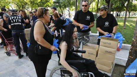 Women receive food parcels from Golden Dawn, 1 Aug 12