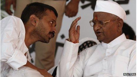 Veteran Indian social activist Anna Hazare (R) speaks to Arvind Kejriwal, a member of his team during their hunger strike in New Delhi August 2, 2012. A